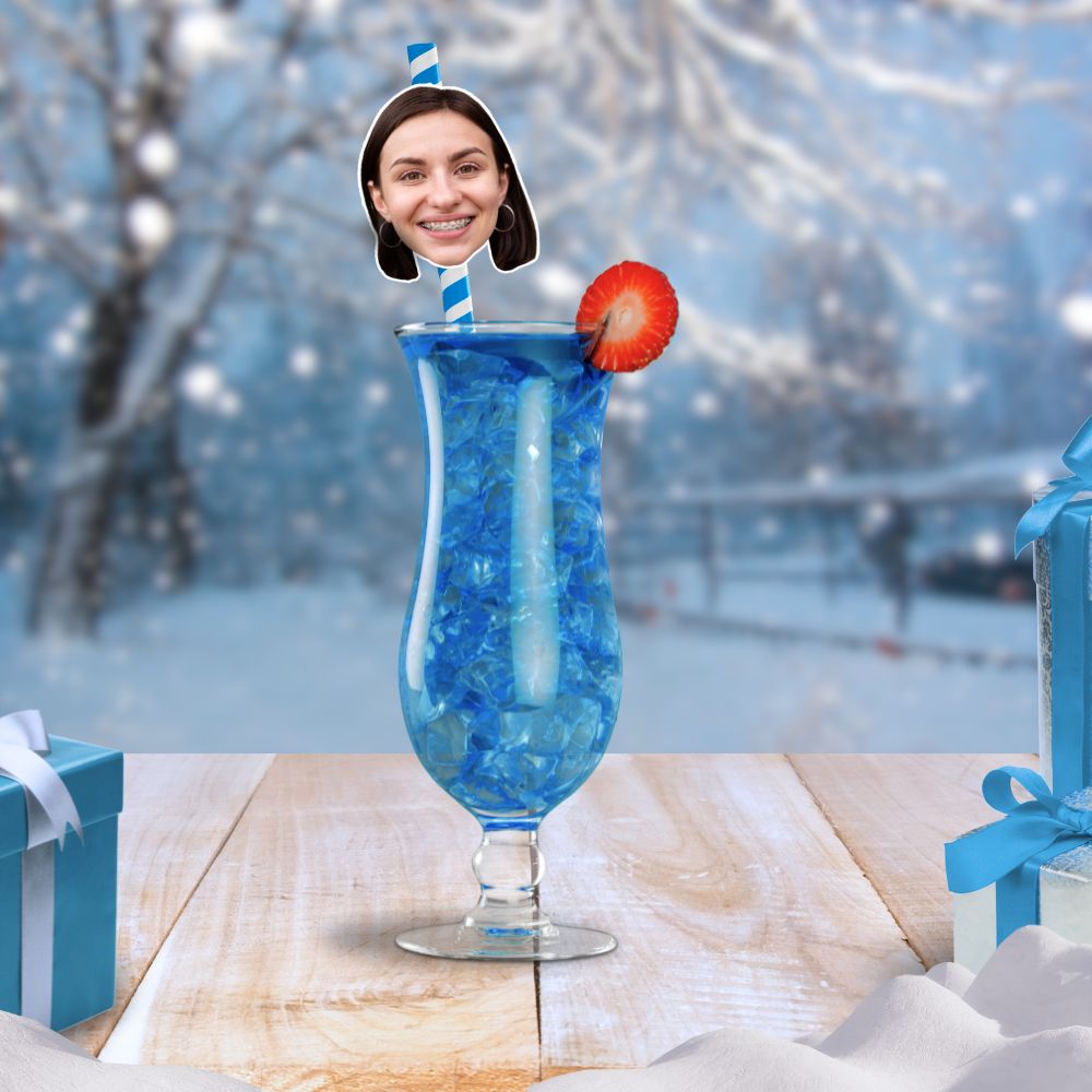 Blue cocktail with a personalised face straw, matching a winter party theme