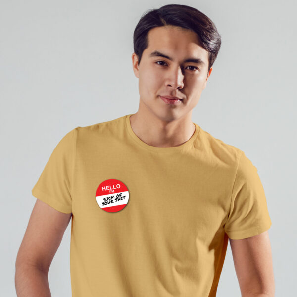 Sick Of Your Shit badge on model